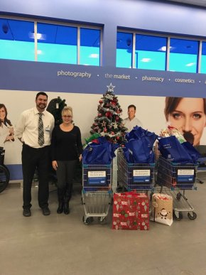 Recreation Therapist Chantell Meeks accepts Christmas gifts for Extendicare Fort Macleod residents.