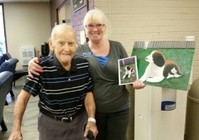 Dick , the resident and Gloria, the receptionist at Extendicare London showing the beautiful painting